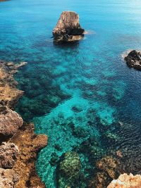 High angle view of rock on sea shore