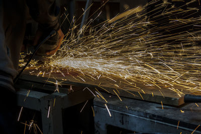 Cropped image of welder working in factory