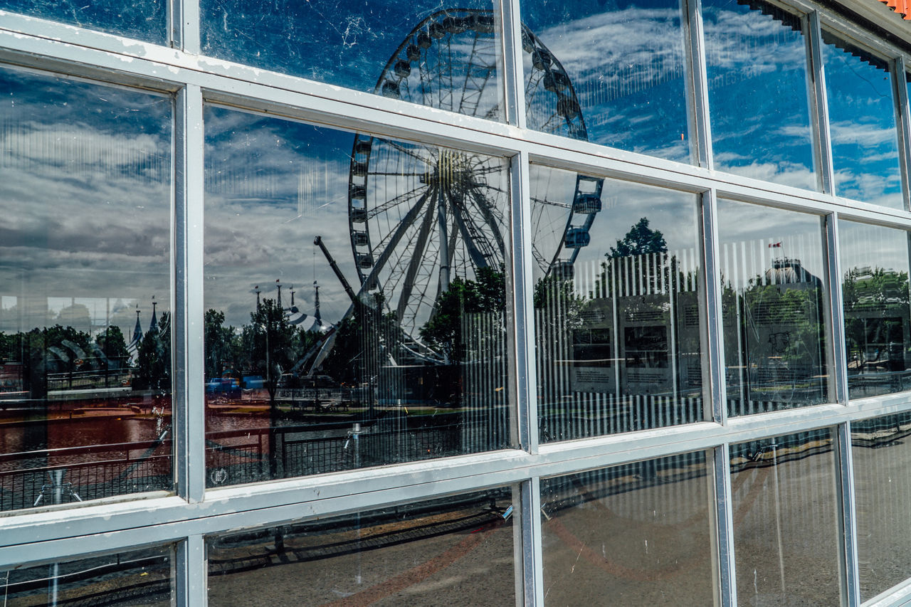 BUILDING SEEN THROUGH GLASS WINDOW