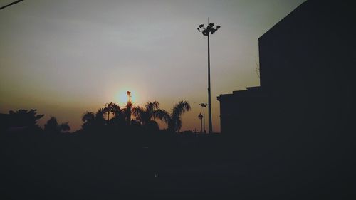 Low angle view of silhouette trees against sky at sunset