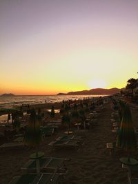 Scenic view of beach against clear sky during sunset