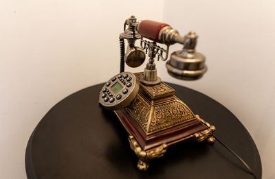 Close-up of telephone booth on table against white background