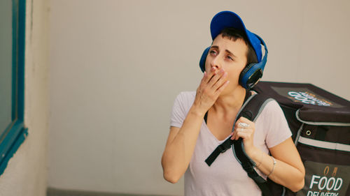 Portrait of young woman using mobile phone at home