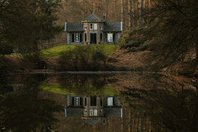 House by lake in forest