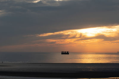 Scenic view of sea against orange sky