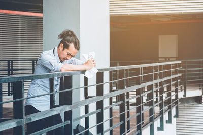 Sad mid adult man standing on footbridge