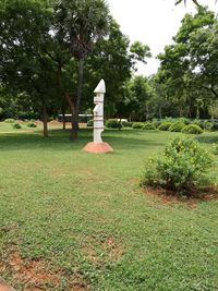 Built structure on field against trees in park