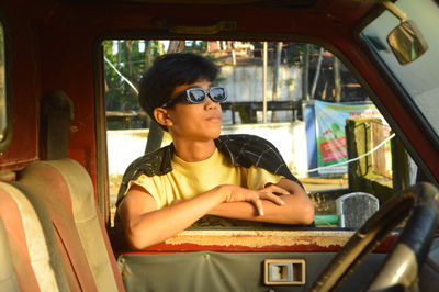 Young woman sitting in car