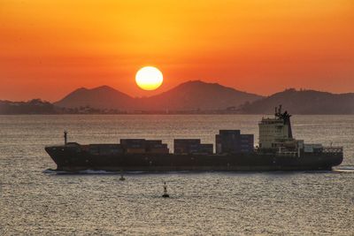 Scenic view of sea against orange sky