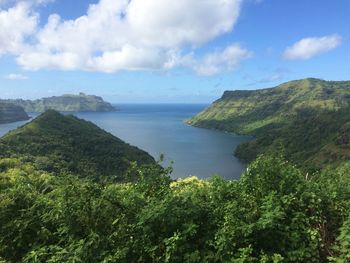 Scenic view of sea and mountains against sky