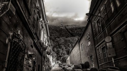 Panoramic view of city street and buildings against sky