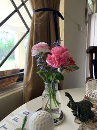 Close-up of flower vase on table at home