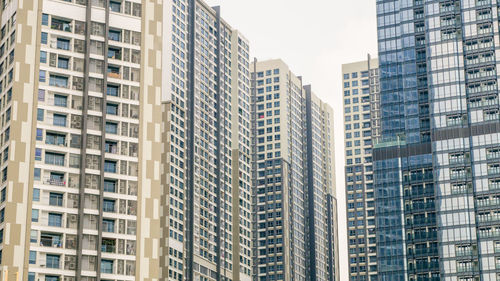 Low angle view of buildings against sky in city