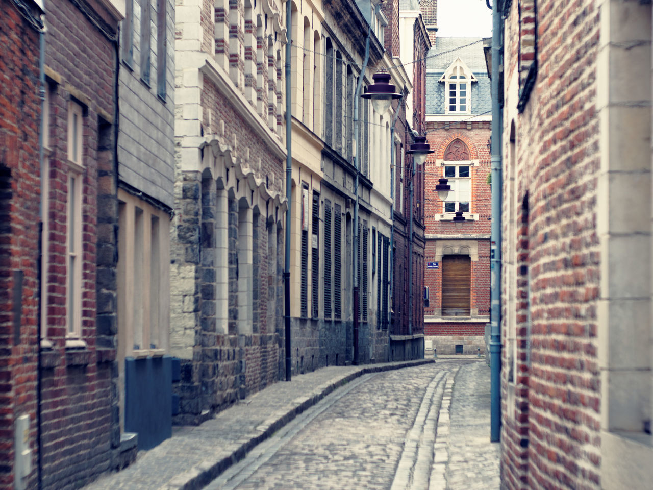 ALLEY IN CITY AGAINST SKY