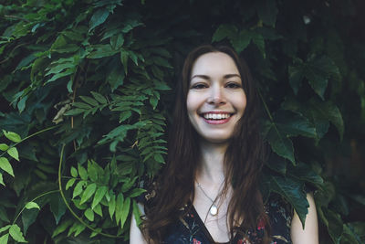 Portrait of smiling young woman with leaves