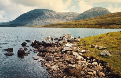 Beautiful landscape scenery of rocky coast of lough inagh mountains in the background at connemara 