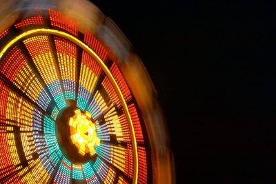 Low angle view of illuminated ferris wheel at night