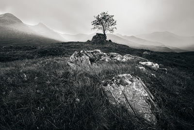 Scenic view of land and mountains against sky