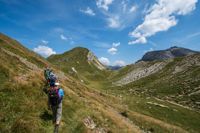 Rear view of friends hiking on mountain