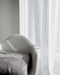 Close-up of woman relaxing on bed at home