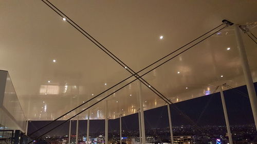 Low angle view of illuminated street lights against sky at night