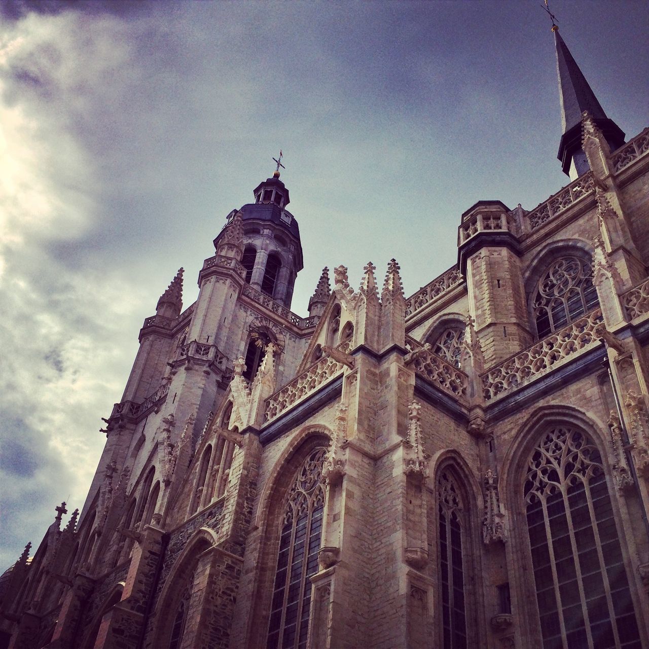 architecture, building exterior, built structure, low angle view, religion, church, place of worship, sky, spirituality, cathedral, history, famous place, travel destinations, travel, cloud - sky, arch, city, tourism