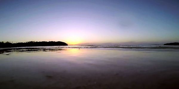 Scenic view of sea against clear sky during sunset