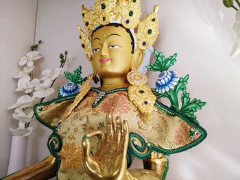 Close-up of buddha statue on table