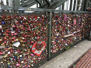 Low angle view of padlocks on metal bridge