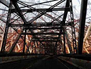 Low angle view of metal structure against sky