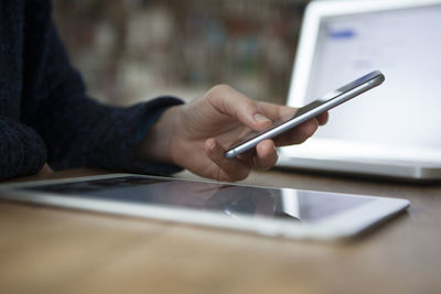 Woman at table using smartphone