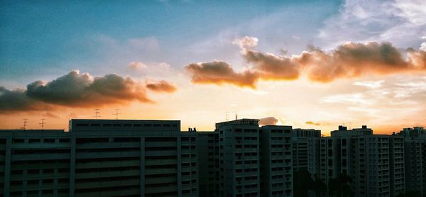 Low angle view of building against sky at sunset