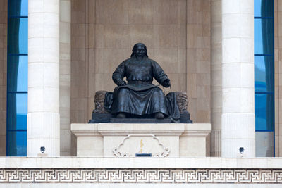 Statue in front of building
