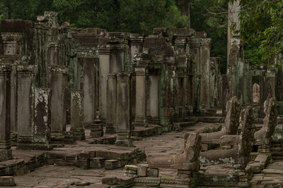 Ruined columns of bayon temple in jungle