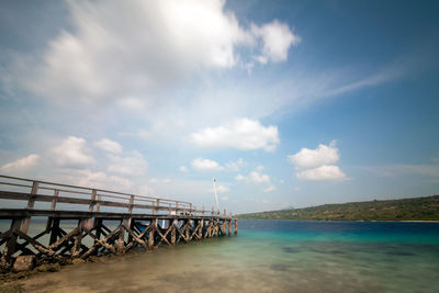 Bridge over sea against sky