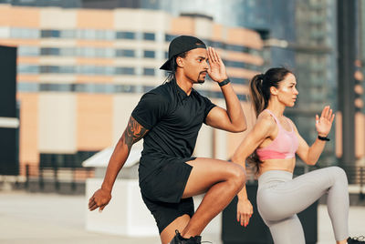 Side view of woman exercising in gym