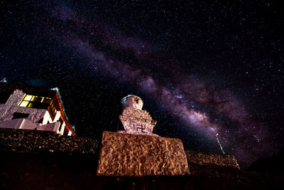 Low angle view of illuminated lanterns against sky at night