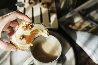 Crop person with yummy toast and coffee