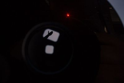 Shadow of hand on camera during eclipse