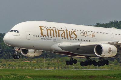 Airplane on airport runway against sky