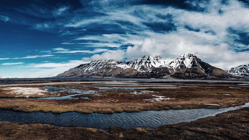 Scenic view of snowcapped mountains against sky