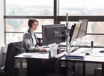 Woman working on table at home