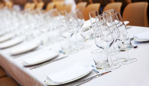 Empty drinking glasses and plates on table