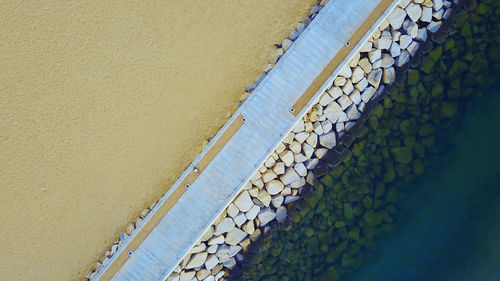 High angle view of railing by wall