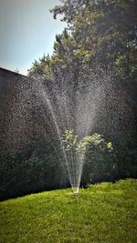 Water splashing in fountain against sky