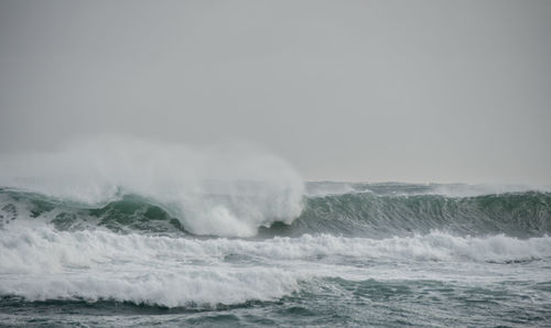 Scenic view of sea against clear sky. big and long wave breaking with all the sea strong