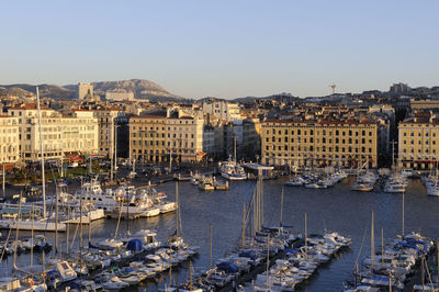 High angle view of harbor by buildings in city