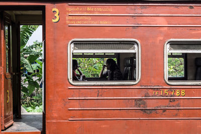 Women sitting by window in train