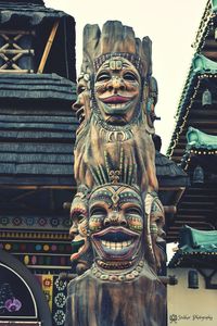 Low angle view of statue against temple