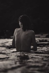 Rear view of a woman looking at sea